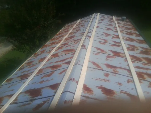 Rusted metal roof panels with new wood purlins before replacement — Storm Damage Roof Repair in Kings Mountain by Roofing Brothers