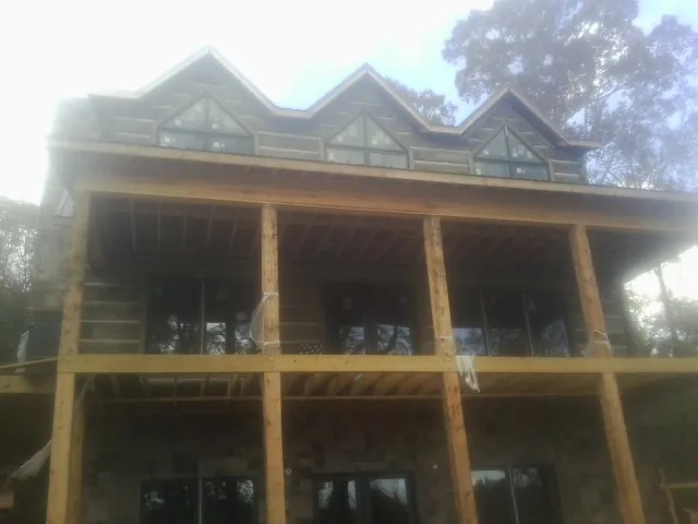 Dormers and porch framing on a large log home under construction in Kings Mountain